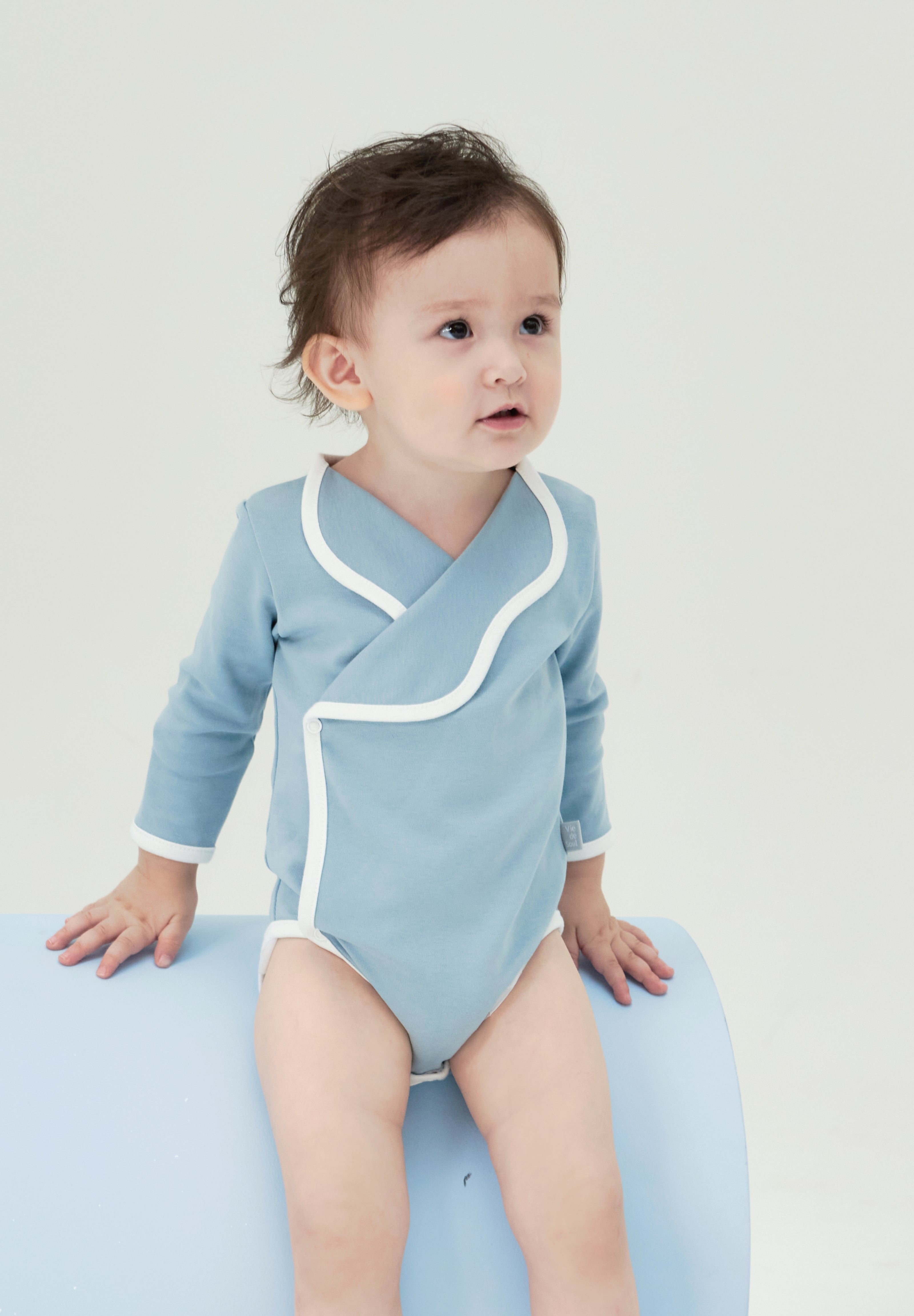 Misty Blue Tailored Bodysuit: Soft, wavy collar with an open button design. Suitable for indoor, outdoor, or special occasions.
