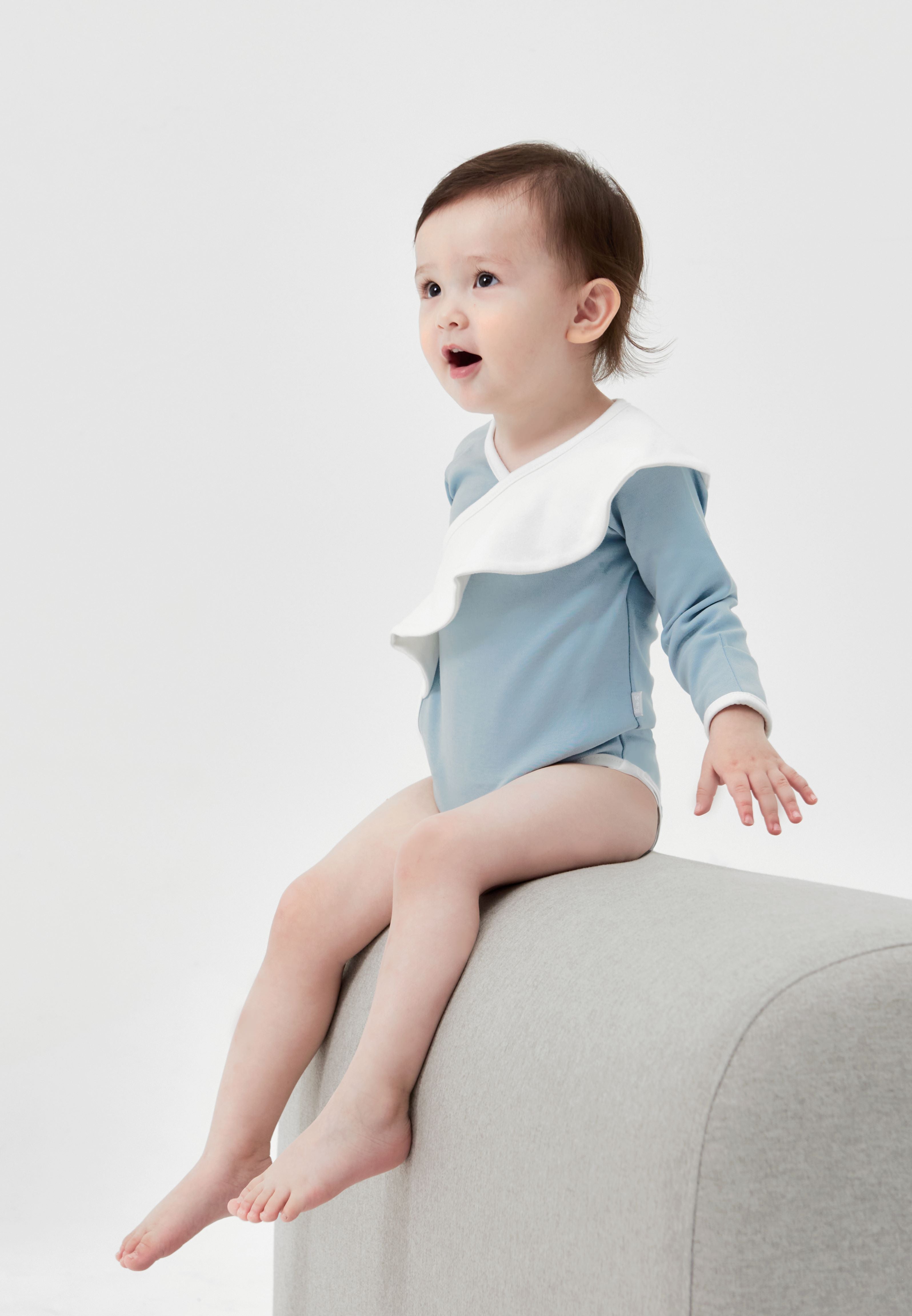Misty Blue Ruffle Bodysuit: Adorable, wavy ruffle design with open button style. Versatile for special occasions or outdoor wear.